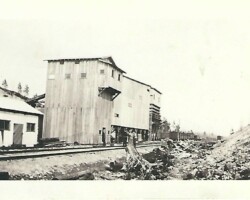 What is this building? Where is it? When? What went on here? What's all this on the side of the track? Old tall building