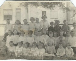 Who were the kids? Is that the teacher? Who is she? Where is this? When? Class photo on the lawn