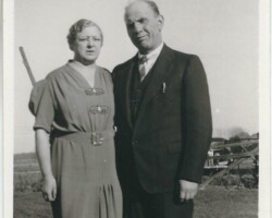 Who are the man and woman? Where were they? When? What kind of auto in background? Special occasion? Man and woman