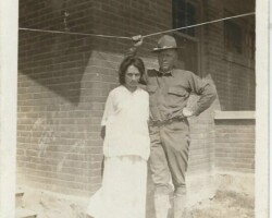 Who is this man and woman? Where was the photo taken? When? What type of uniform is this? Military man posing with woman in white
