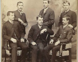 What is the studio name on the lower left? Who are these men? Six men in studio photo