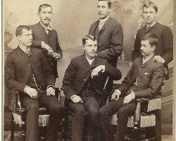 What is the studio name on the lower left? Who are these men? Six men in studio photo